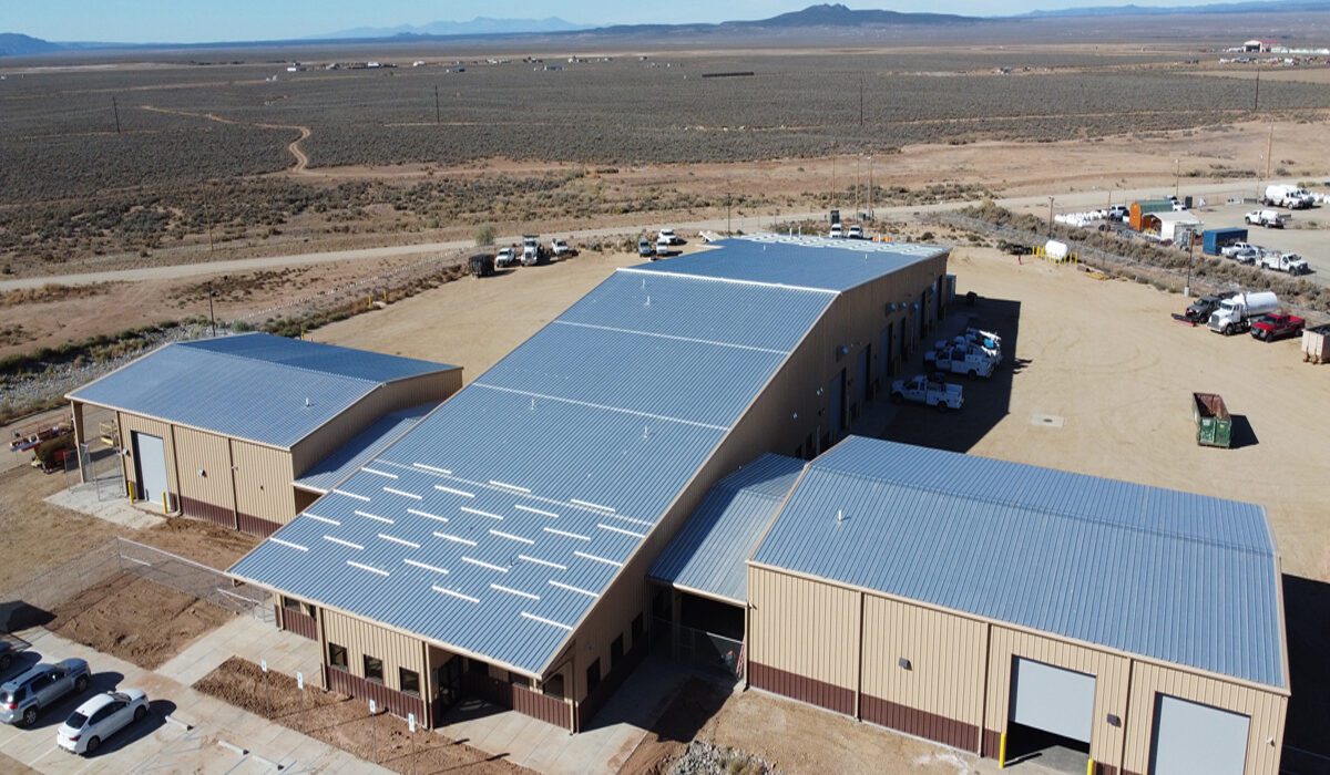 A large building with a roof that has been covered in solar panels.