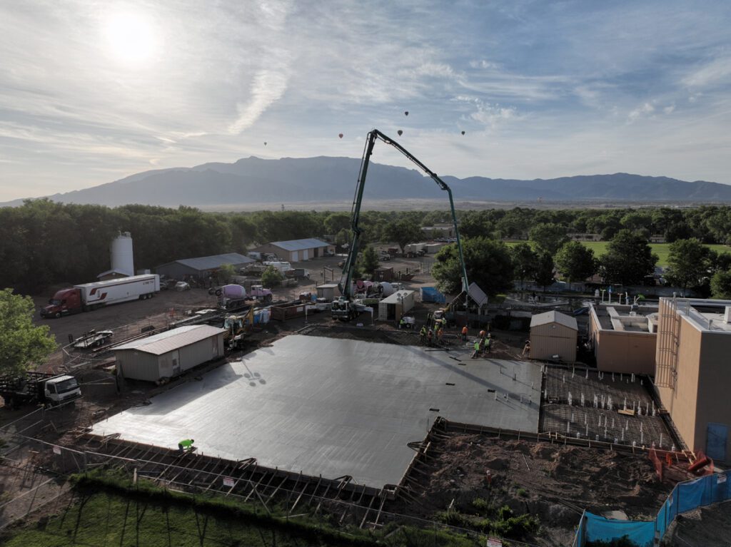 A large concrete slab being poured for a building.