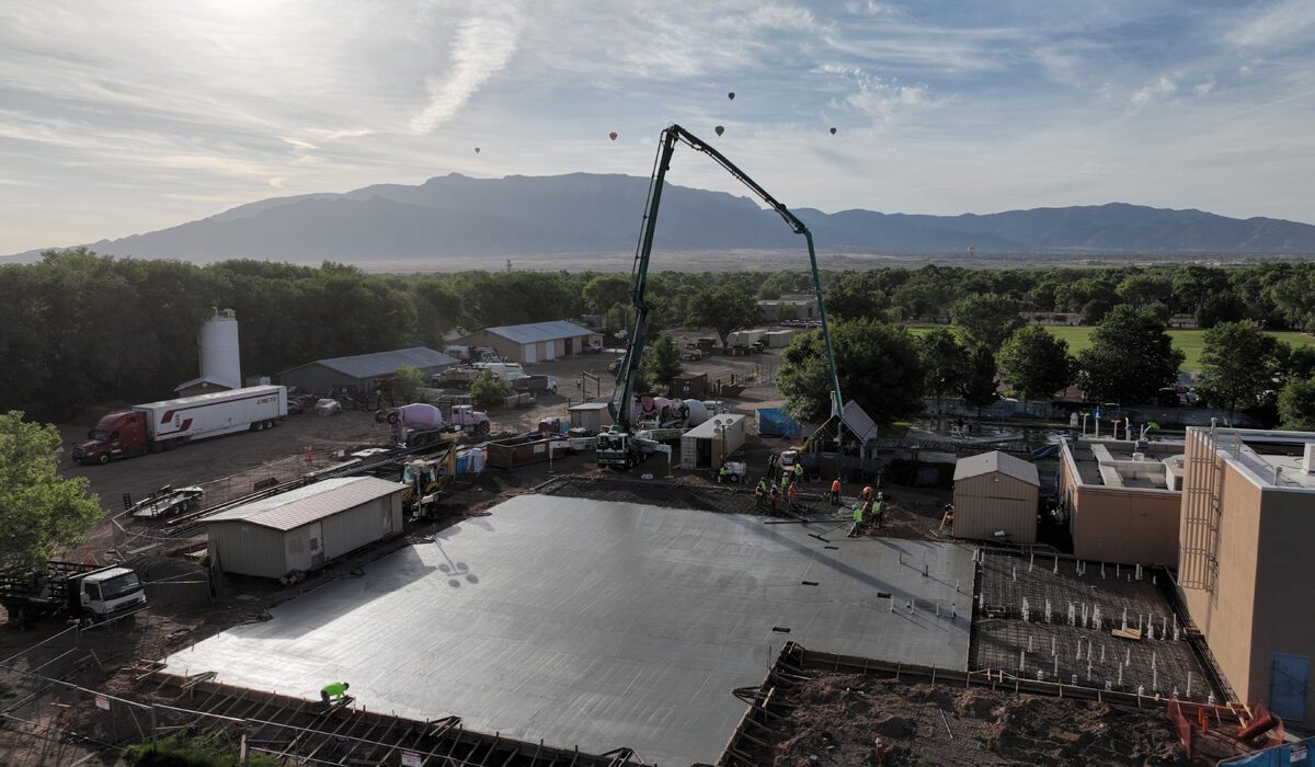 A large concrete slab being poured for a building.